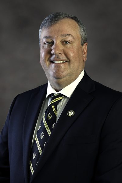 photo of man in suit smiling at the camera