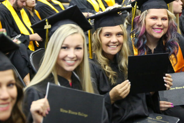 students sitting at graduation