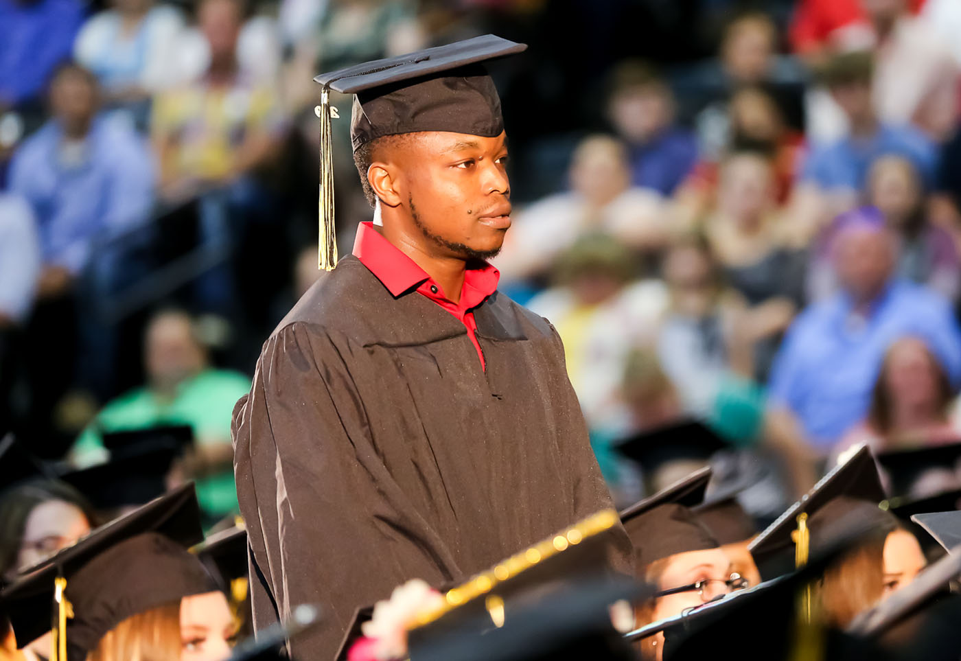 student standing at graduation