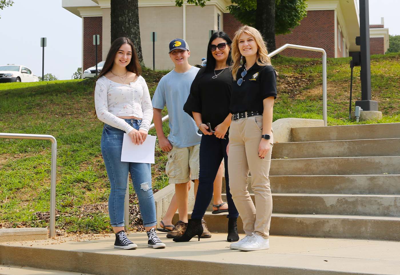 a group of people posing for a photo on some steps