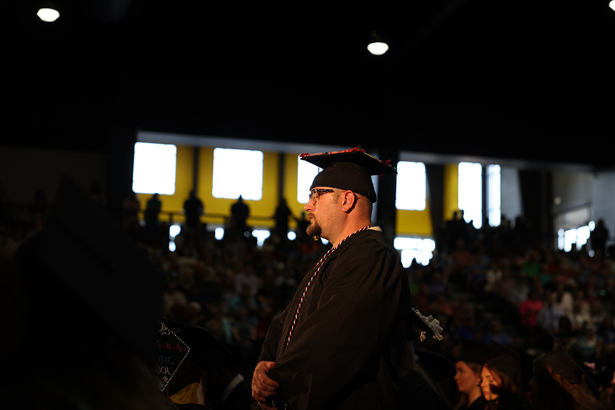 man in graduation cap and gown standing